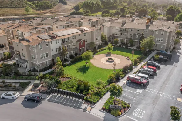 an aerial view of a house with a garden and lake view