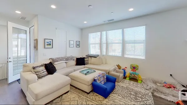 a bedroom with furniture and a wooden floor