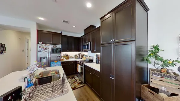 a kitchen with refrigerator and microwave