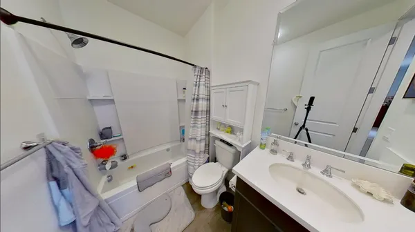 a bathroom with a sink vanity mirror and toilet