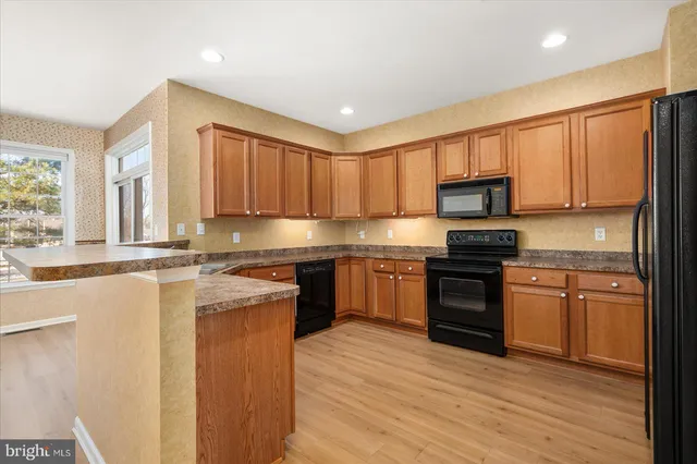 a kitchen with a sink stove and refrigerator