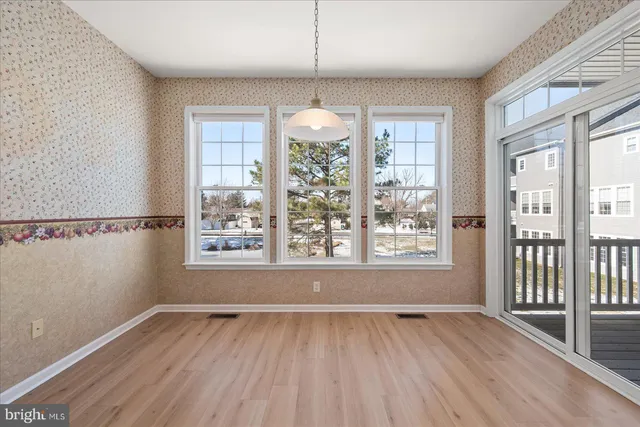 a view of a kitchen with granite countertop a large counter top stainless steel appliances and cabinets