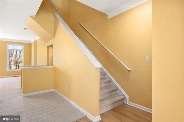 a bedroom with a large bed a chandelier and a window