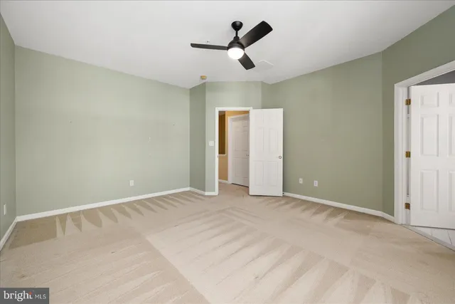 a spacious bathroom with a double vanity sink mirror and bathtub
