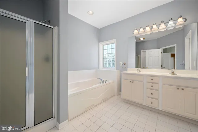 a bathroom with bathtub and window