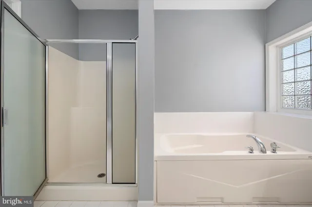 a white bath tub sitting next to a window