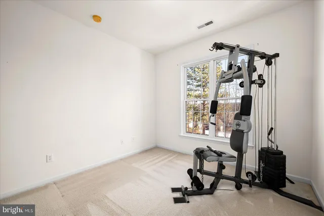 a view of a water heater room with a ceiling fan