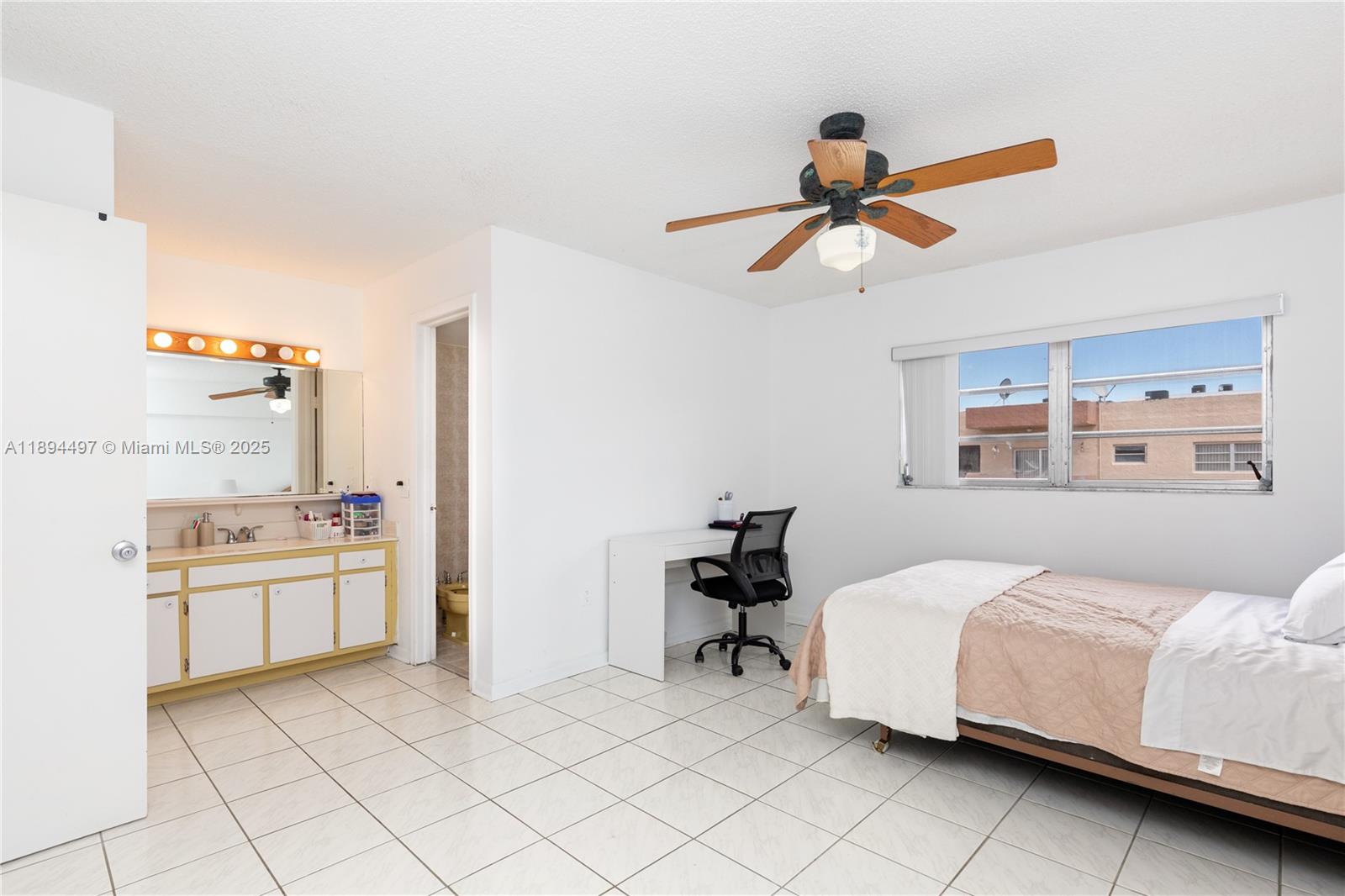 1630 West 46th Street, Unit 514B Hialeah, FL 33012 - Photo 12 of 26 a bedroom with a bed and a chandelier