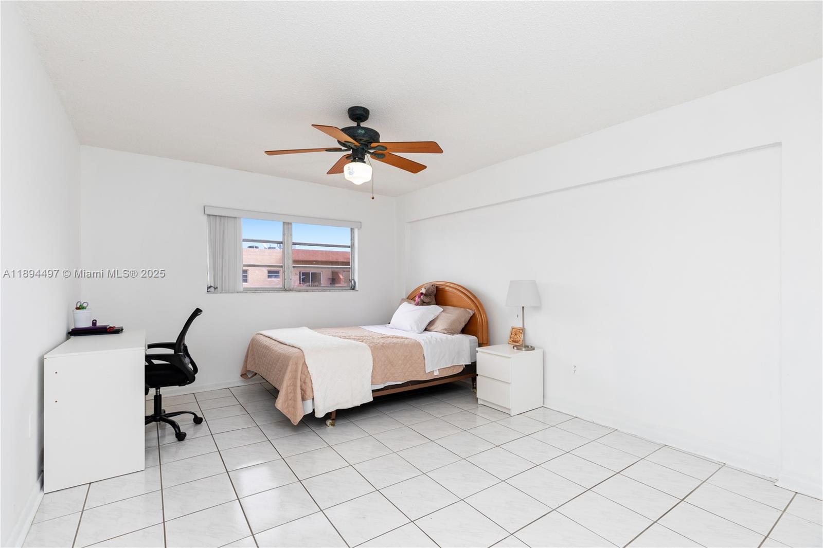 1630 West 46th Street, Unit 514B Hialeah, FL 33012 - Photo 13 of 26 a bed room with a bed and a chandelier