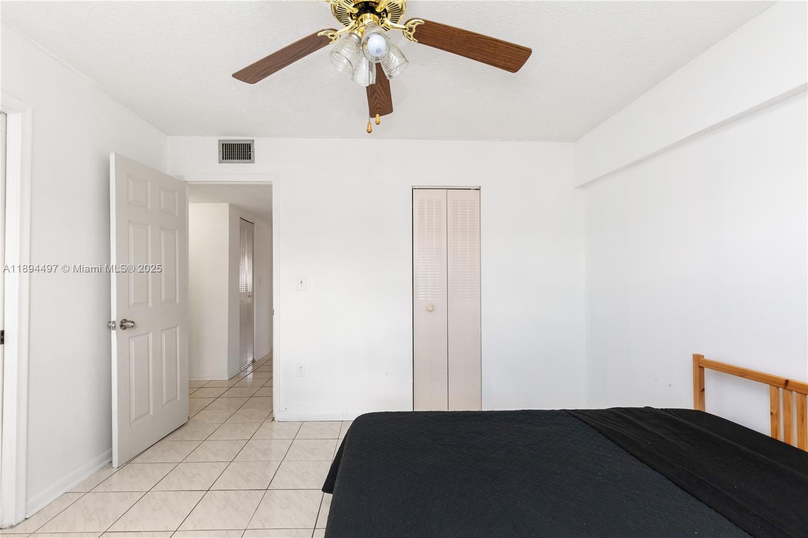 1630 West 46th Street, Unit 514B Hialeah, FL 33012 - Photo 15 of 26 a bedroom with a bed and a chandelier fan