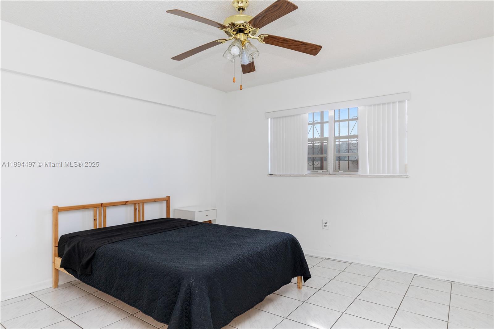 1630 West 46th Street, Unit 514B Hialeah, FL 33012 - Photo 16 of 26 a bedroom with a bed and a window