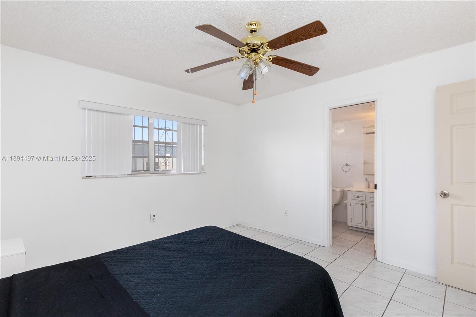 1630 West 46th Street, Unit 514B Hialeah, FL 33012 - Photo 18 of 26 a bedroom with a bed and a ceiling fan