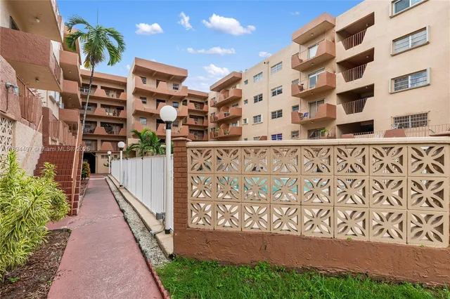 a view of building with swimming pool outdoor seating