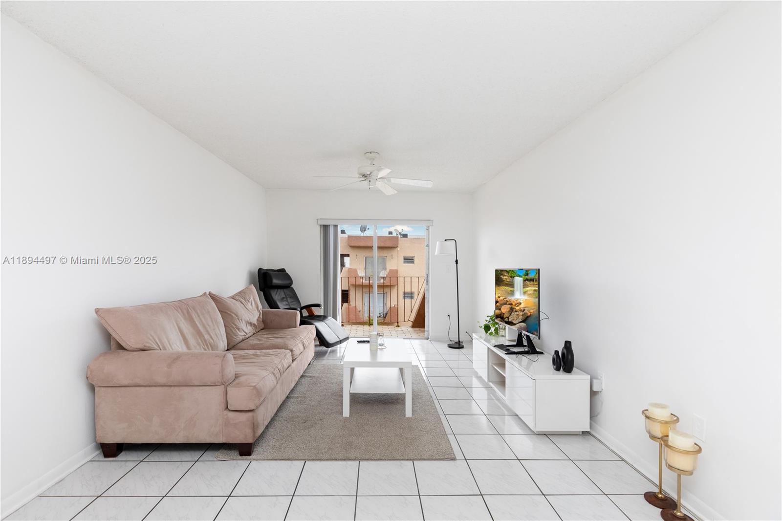 1630 West 46th Street, Unit 514B Hialeah, FL 33012 - Photo 4 of 26 a living room with furniture and a couch