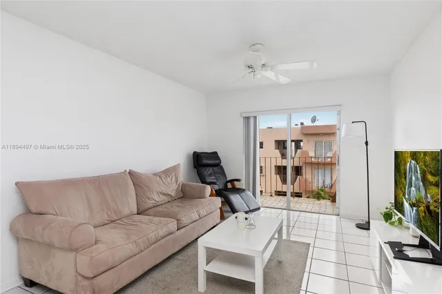 a living room with furniture and a dining table with painted walls