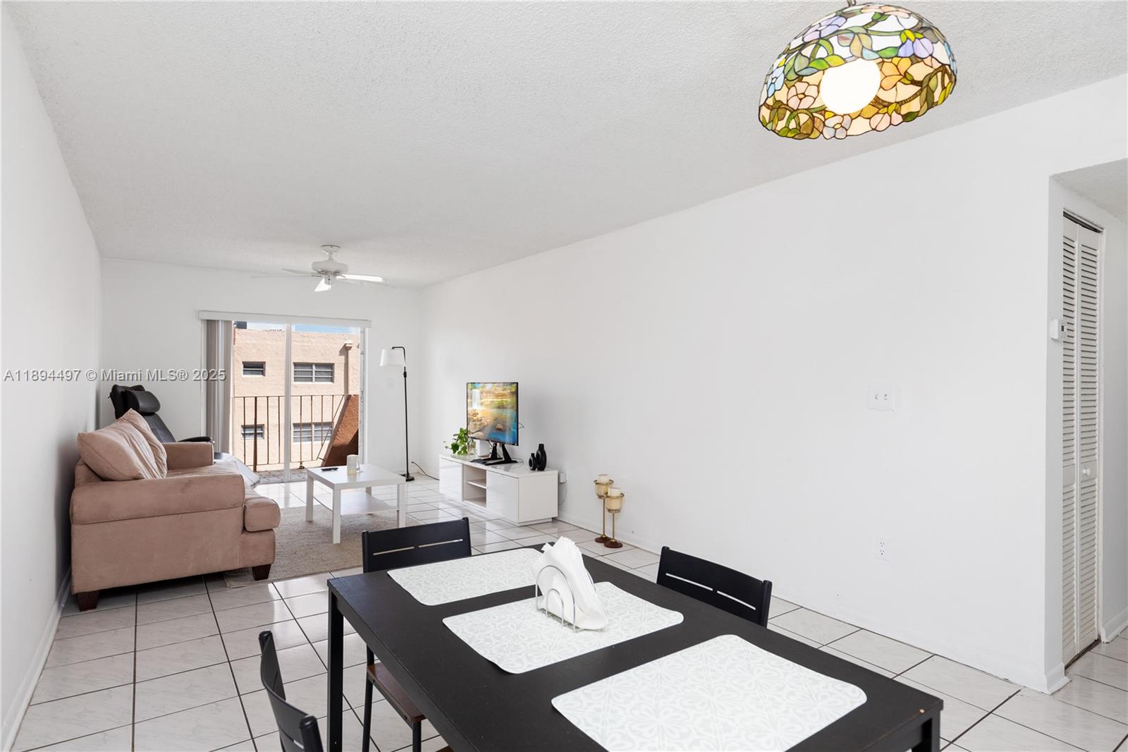 1630 West 46th Street, Unit 514B Hialeah, FL 33012 - Photo 8 of 26 a living room with furniture and a window