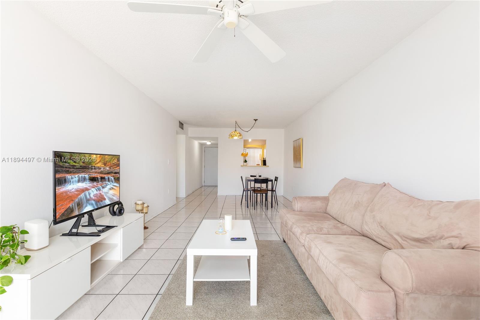 1630 West 46th Street, Unit 514B Hialeah, FL 33012 - Photo 9 of 26 a living room with furniture and a flat screen tv