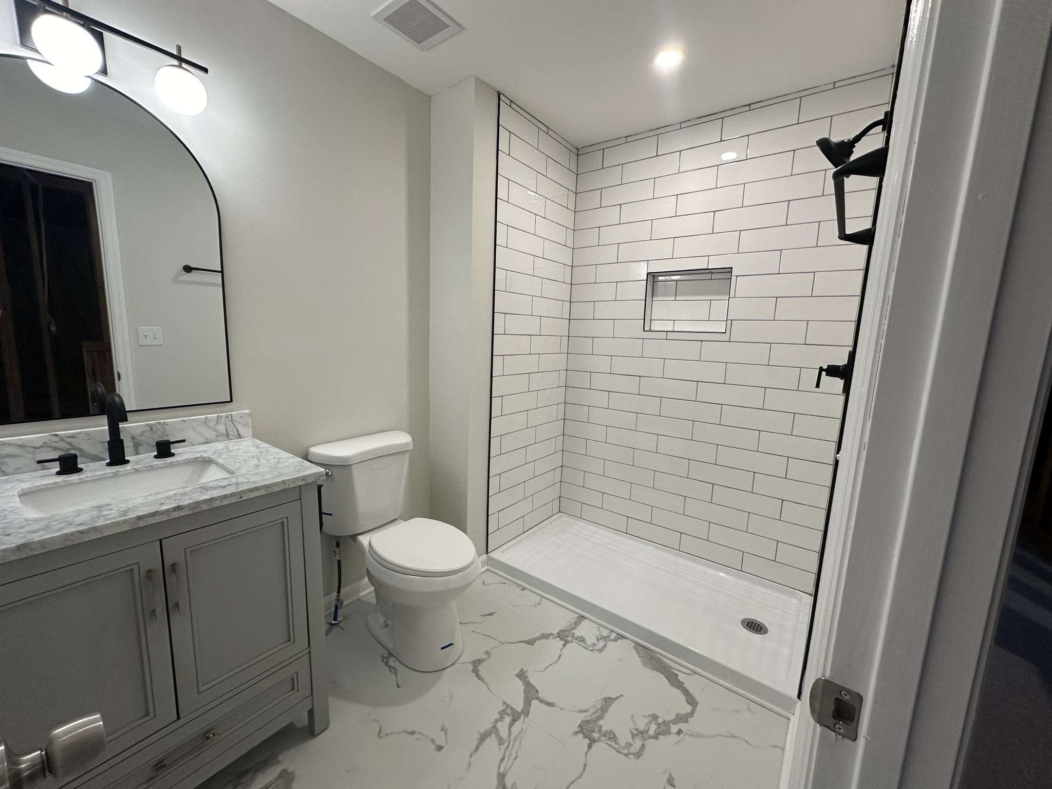 4859 Chelanie Circle Murfreesboro, TN 37129 - Photo 2 of 27 a bathroom with a shower toilet and sink