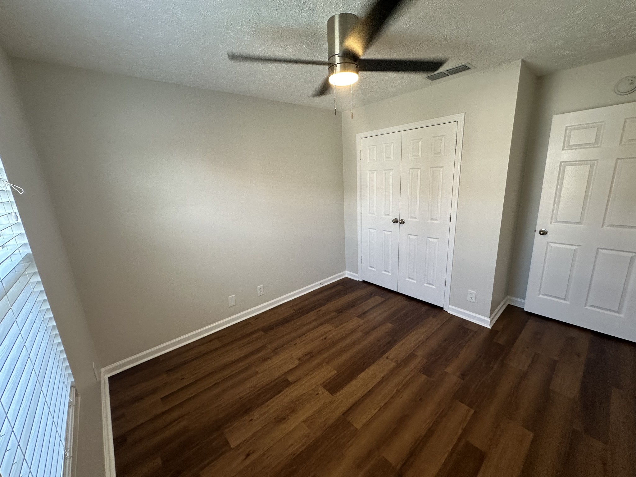 4859 Chelanie Circle Murfreesboro, TN 37129 - Photo 4 of 27 a view of an empty room with wooden floor and a window