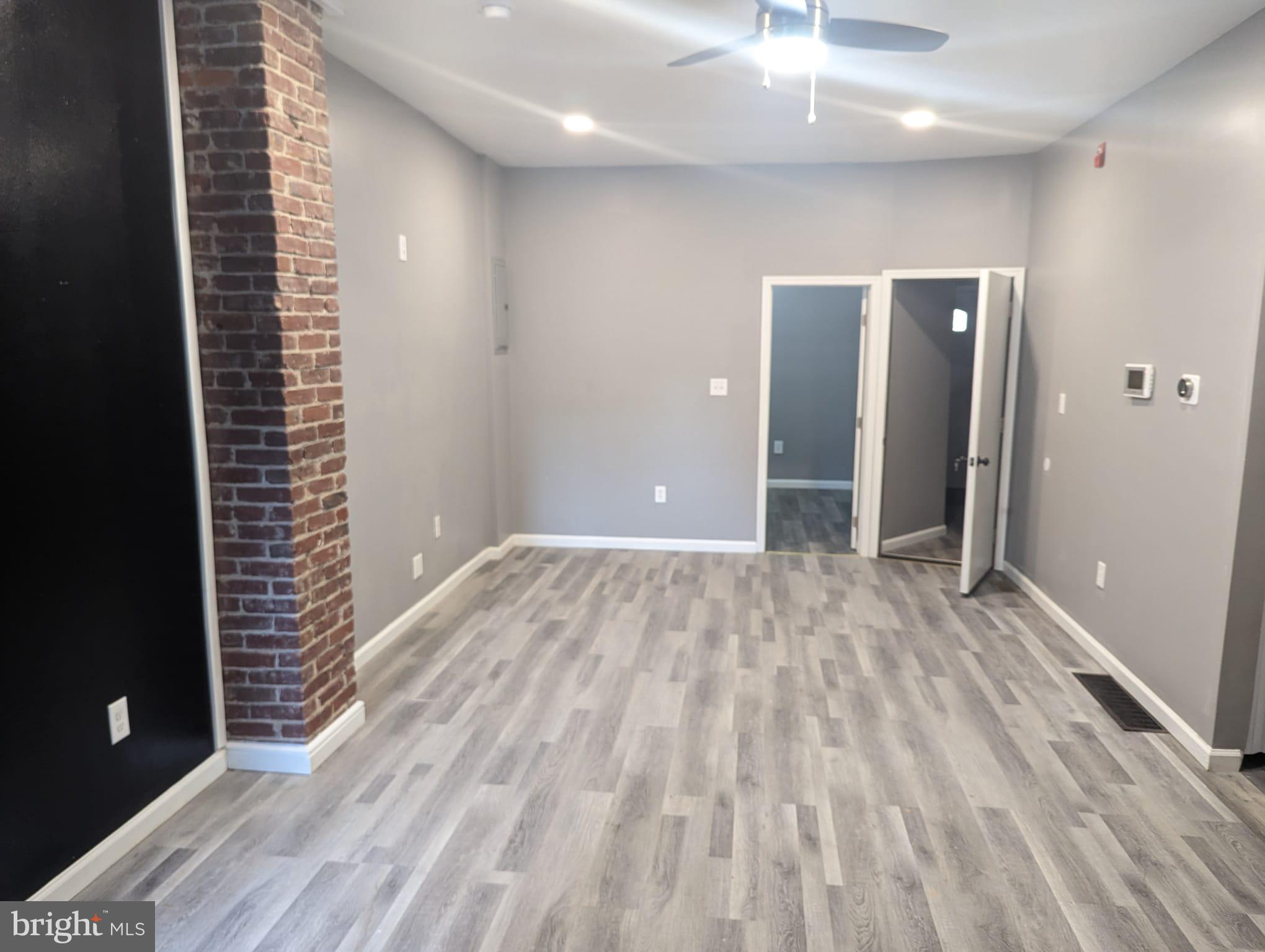 883 North Preston Street Philadelphia, PA 19104 - Photo 4 of 12 an empty room with wooden floor and windows