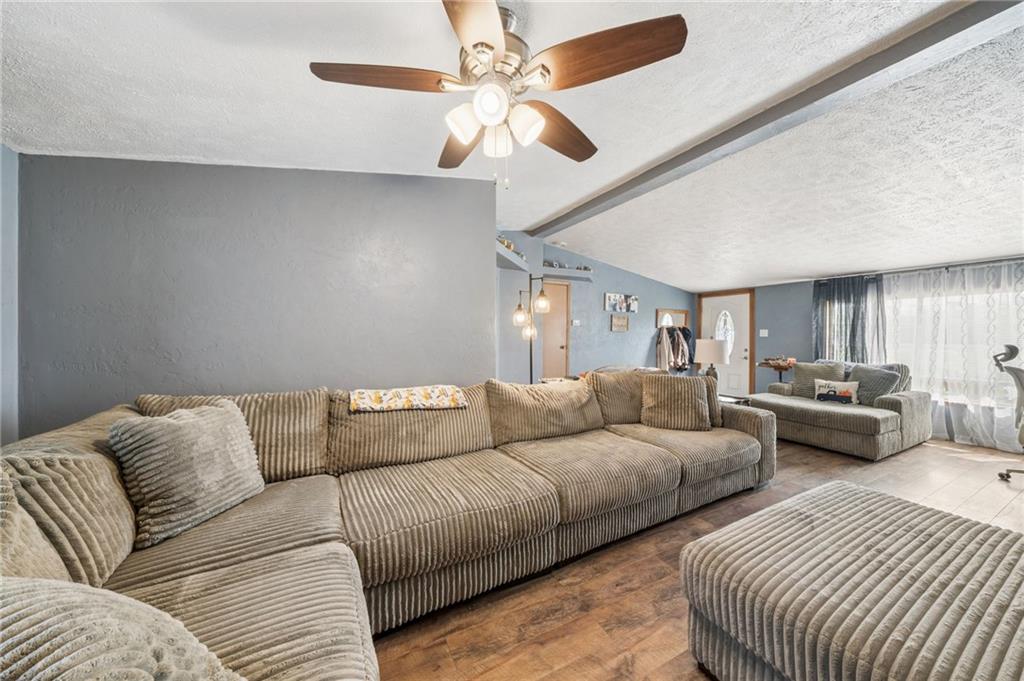 275 Adamik Road Clarksville, PA 15322 - Photo 27 of 39 a living room with furniture and a chandelier