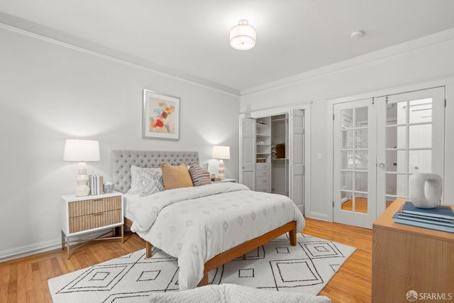 a bedroom with a large bed and a rug