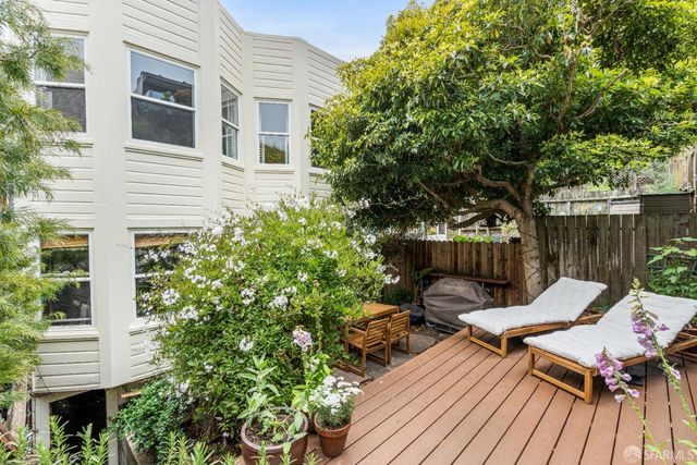 a view of a chairs and table in the balcony