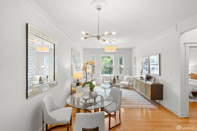a view of a dining room with furniture window and wooden floor
