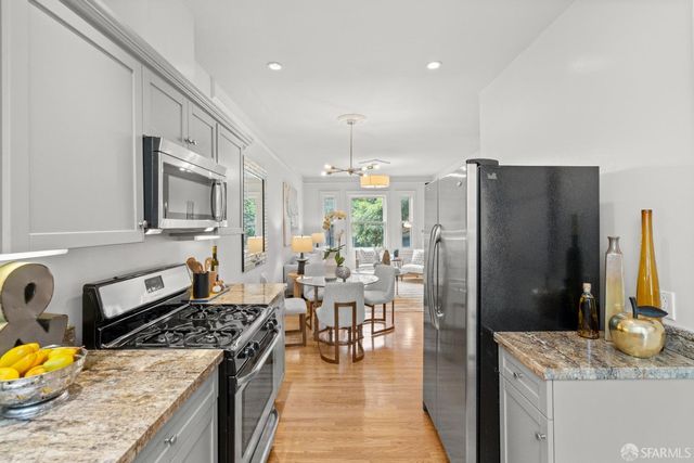 a kitchen with stainless steel appliances granite countertop a refrigerator stove and sink