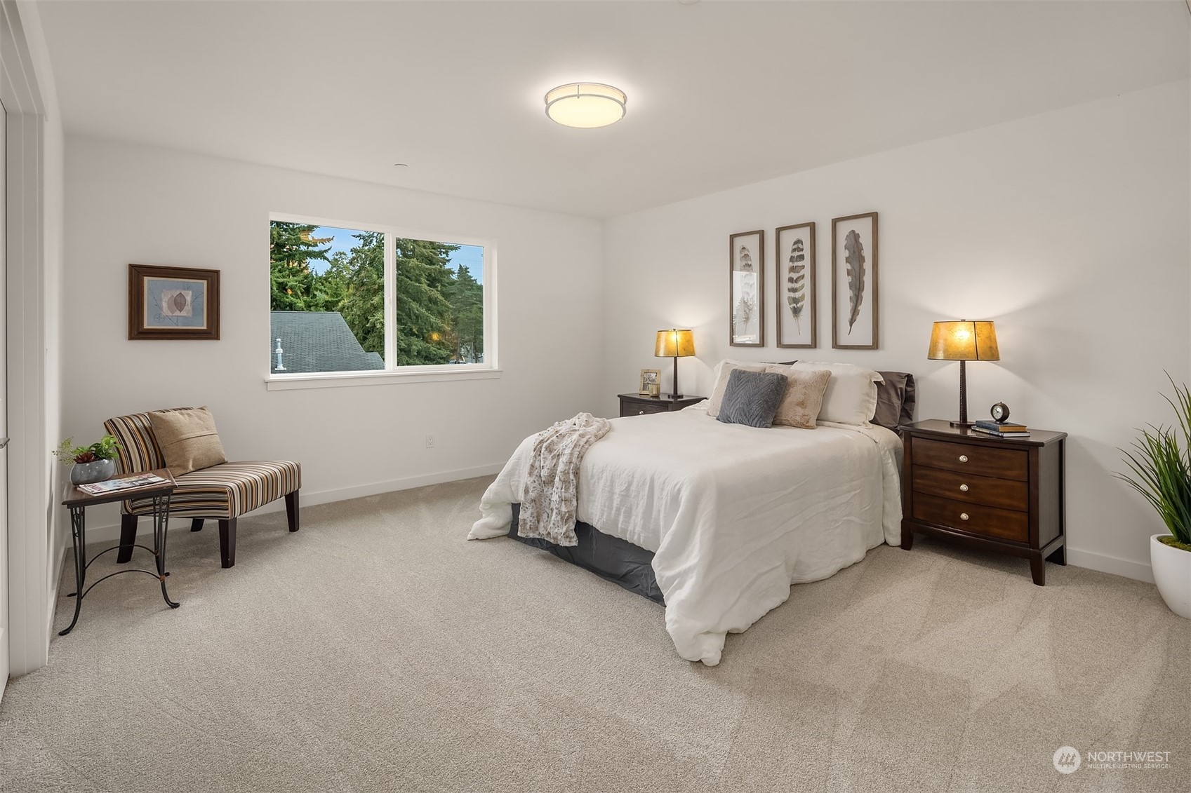 115 Southwest 181st Place, Unit C11 Normandy Park, WA 98166 - Photo 11 of 26 a bedroom with a bed and a lamp