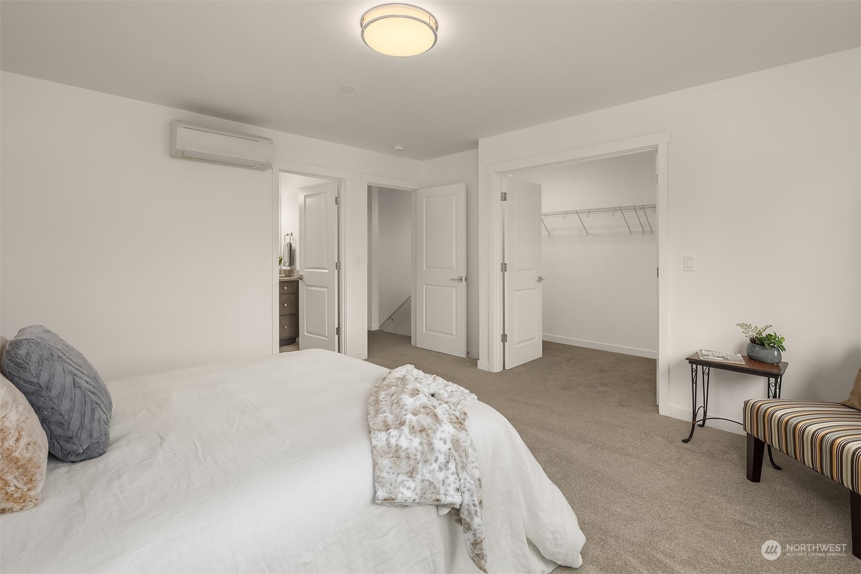 115 Southwest 181st Place, Unit C11 Normandy Park, WA 98166 - Photo 12 of 26 a bedroom with a bed and a chair
