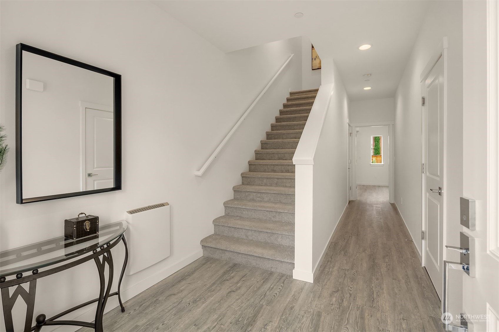 115 Southwest 181st Place, Unit C11 Normandy Park, WA 98166 - Photo 17 of 26 a view of a hallway with wooden floor and staircase