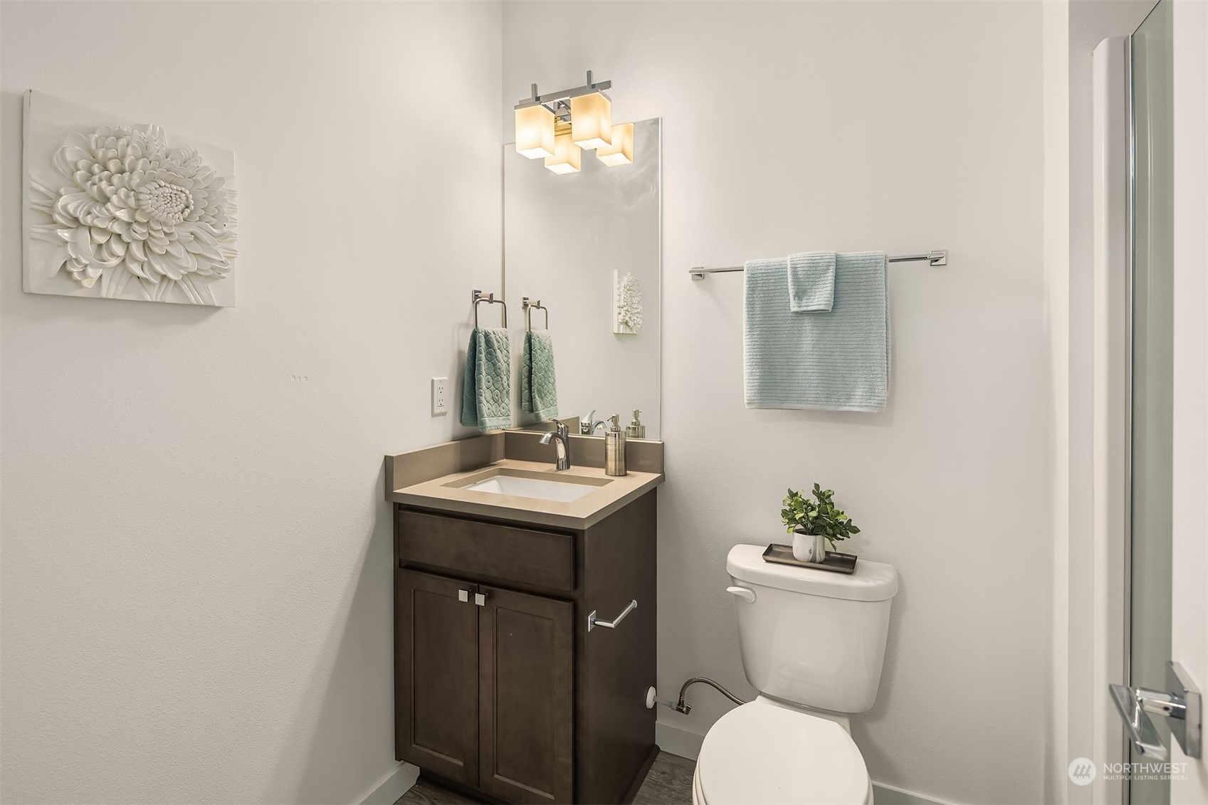115 Southwest 181st Place, Unit C11 Normandy Park, WA 98166 - Photo 19 of 26 a bathroom with a toilet a sink and mirror