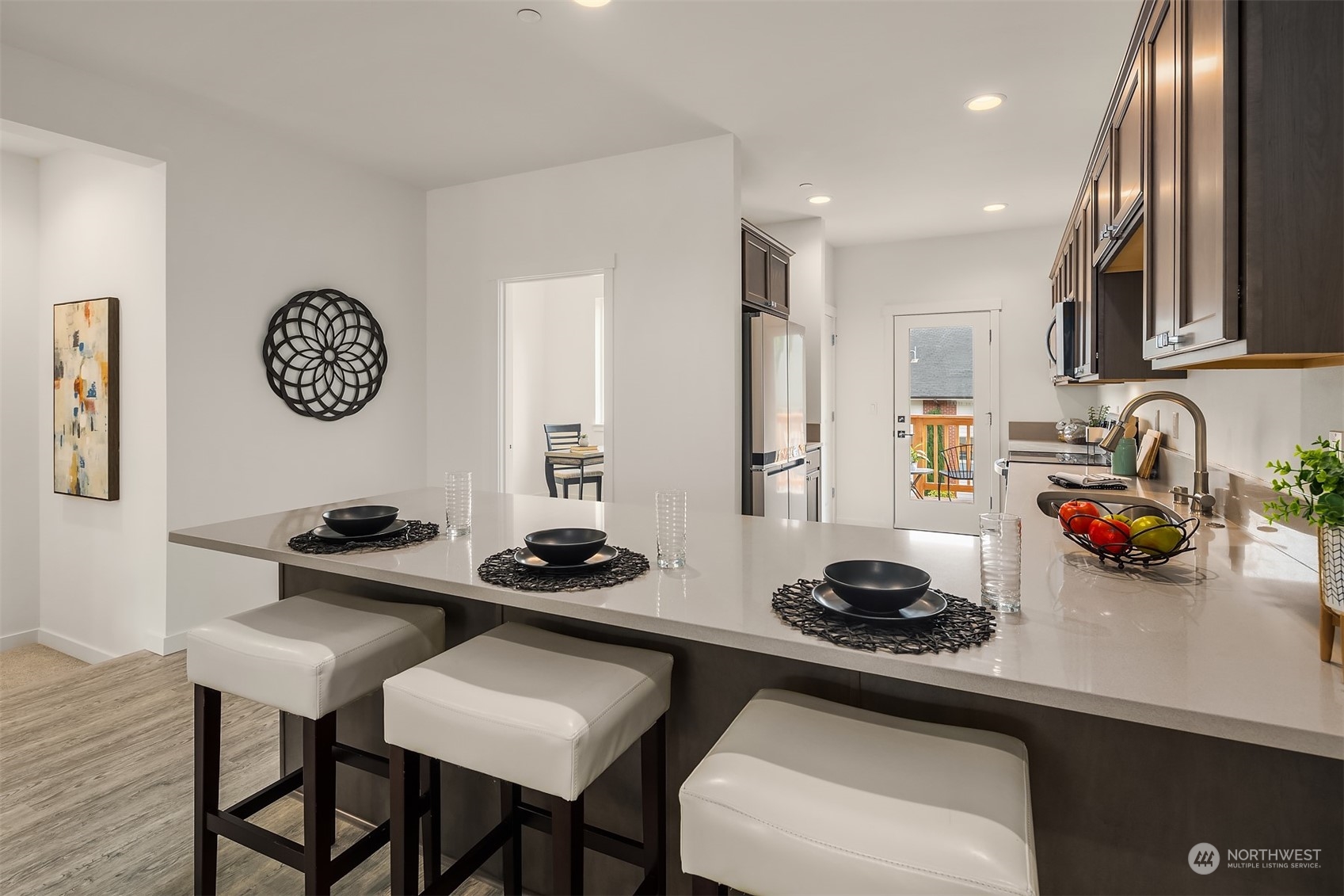 115 Southwest 181st Place, Unit C11 Normandy Park, WA 98166 - Photo 2 of 26 a kitchen with a sink a stove and chairs