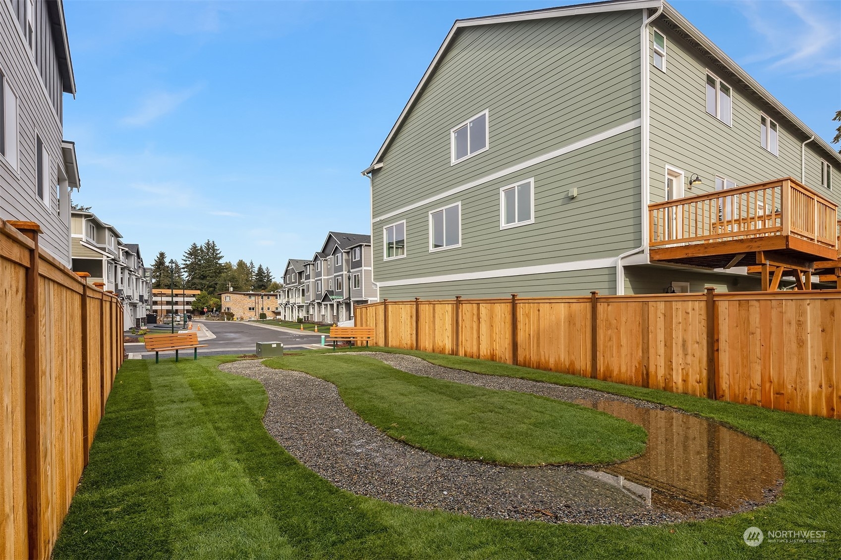 115 Southwest 181st Place, Unit C11 Normandy Park, WA 98166 - Photo 23 of 26 a front view of a house with a yard table and chairs