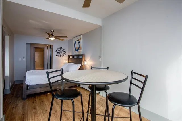 a view of a room with furniture and wooden floor