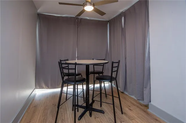 a view of a dining room with furniture and wooden floor