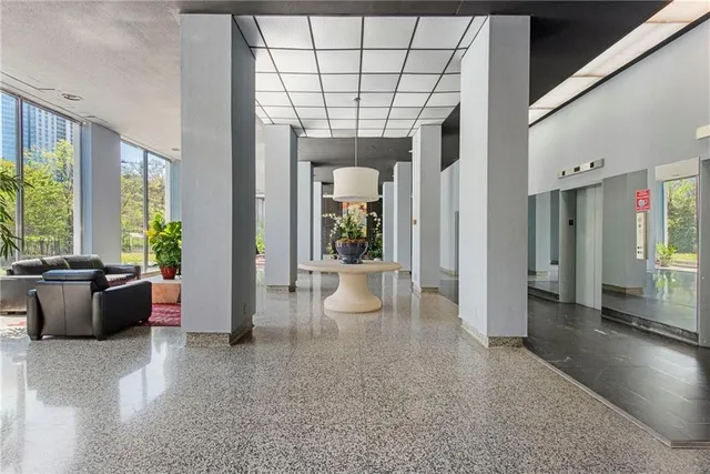 a living room with furniture and a potted plant