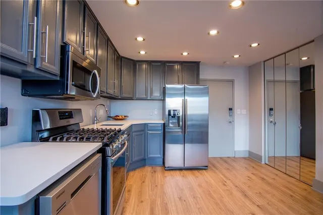 a kitchen with stainless steel appliances granite countertop a refrigerator sink and cabinets