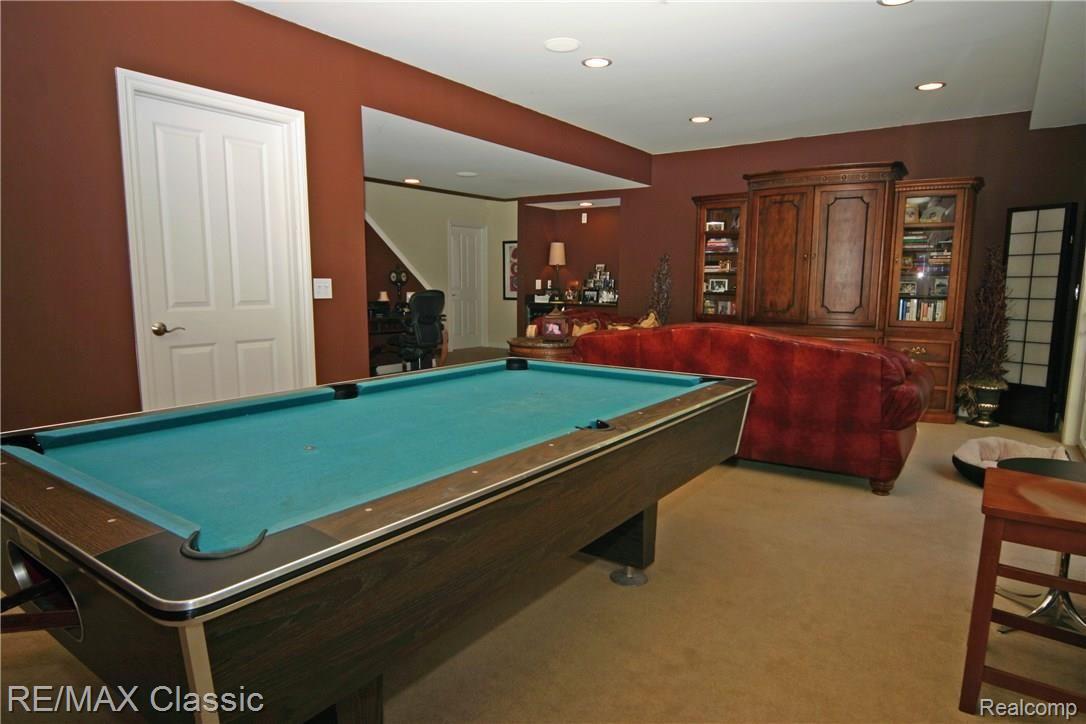 679 Mountain Circle Rochester, MI 48306 - Photo 19 of 30 The door behind the pool table is a large storage area.