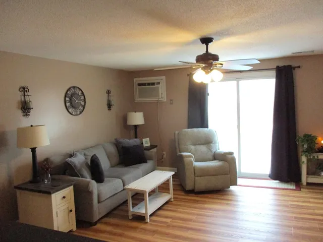 a living room with furniture and a lamp