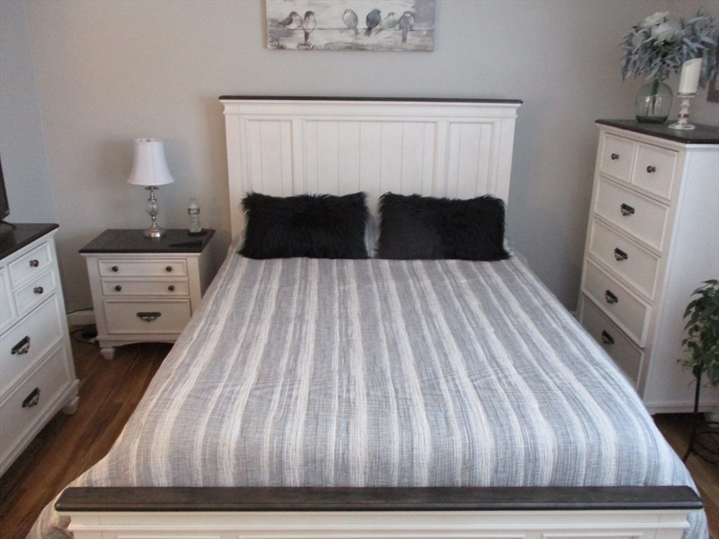 1475 Braley Road, Unit 21 New Bedford, MA 02745 - Photo 14 of 20 a bedroom with a bed and a night stand