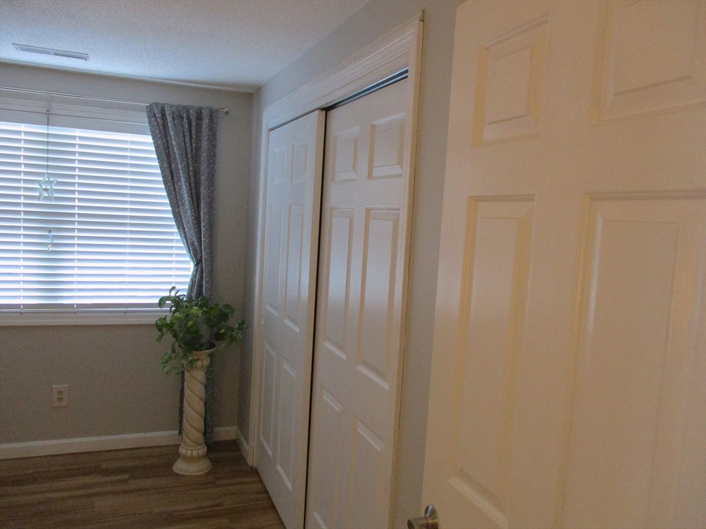 1475 Braley Road, Unit 21 New Bedford, MA 02745 - Photo 15 of 20 a view of a closet with wooden floor