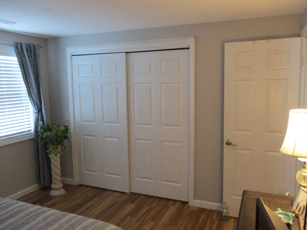 1475 Braley Road, Unit 21 New Bedford, MA 02745 - Photo 16 of 20 an empty room with wooden floor and closet area