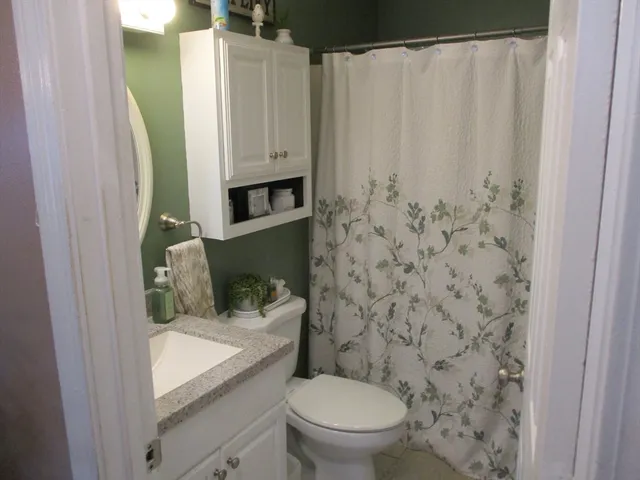 a bathroom with a toilet and a shower