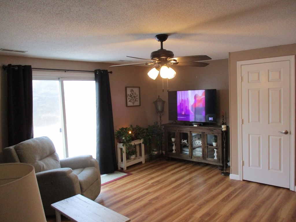 1475 Braley Road, Unit 21 New Bedford, MA 02745 - Photo 7 of 20 a living room with furniture and a flat screen tv