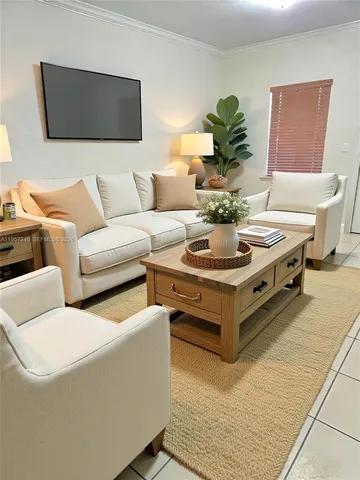 a living room with furniture and a potted plant