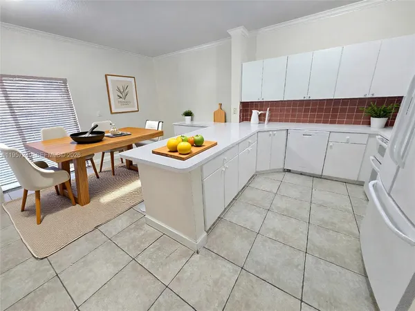 a kitchen with a sink a stove cabinets and utility room