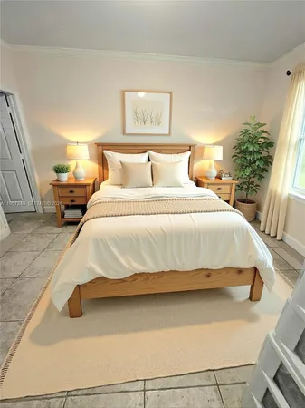 a bedroom with a bed and window