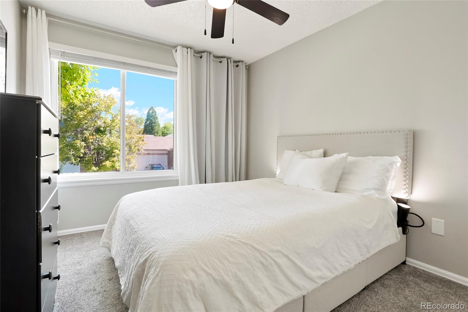 9191 Hickory Circle Highlands Ranch, CO 80126 - Photo 18 of 27 a large bed sitting in a bedroom next to a window